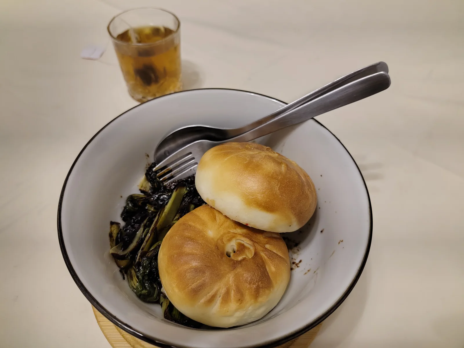 Baozi steamed in air fryer and Bok Choi fried in garlic and soy sauce as well as a glass of Oolong tea.