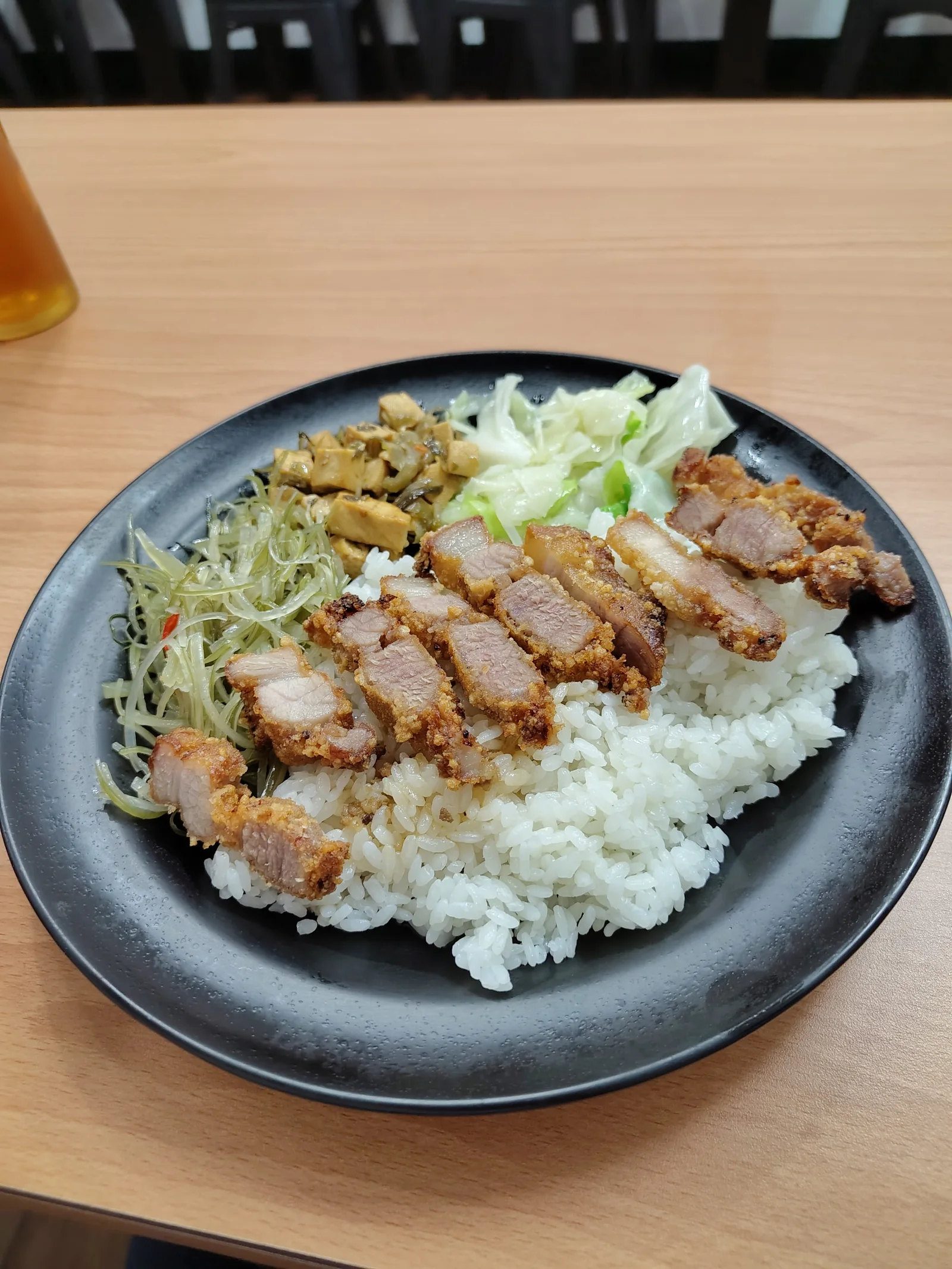 Pork cutlet with rice and steamed vegetables.