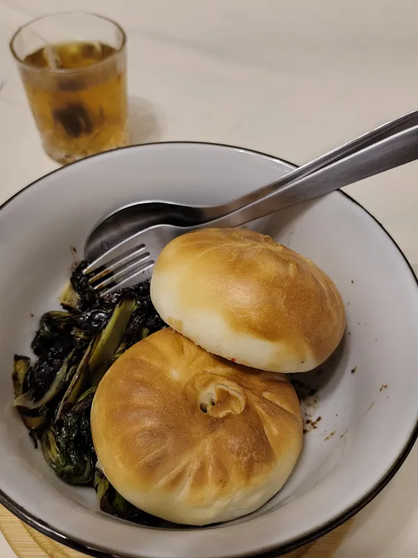 Baozi steamed in air fryer and Bok Choi fried in garlic and soy sauce as well as a glass of Oolong tea.